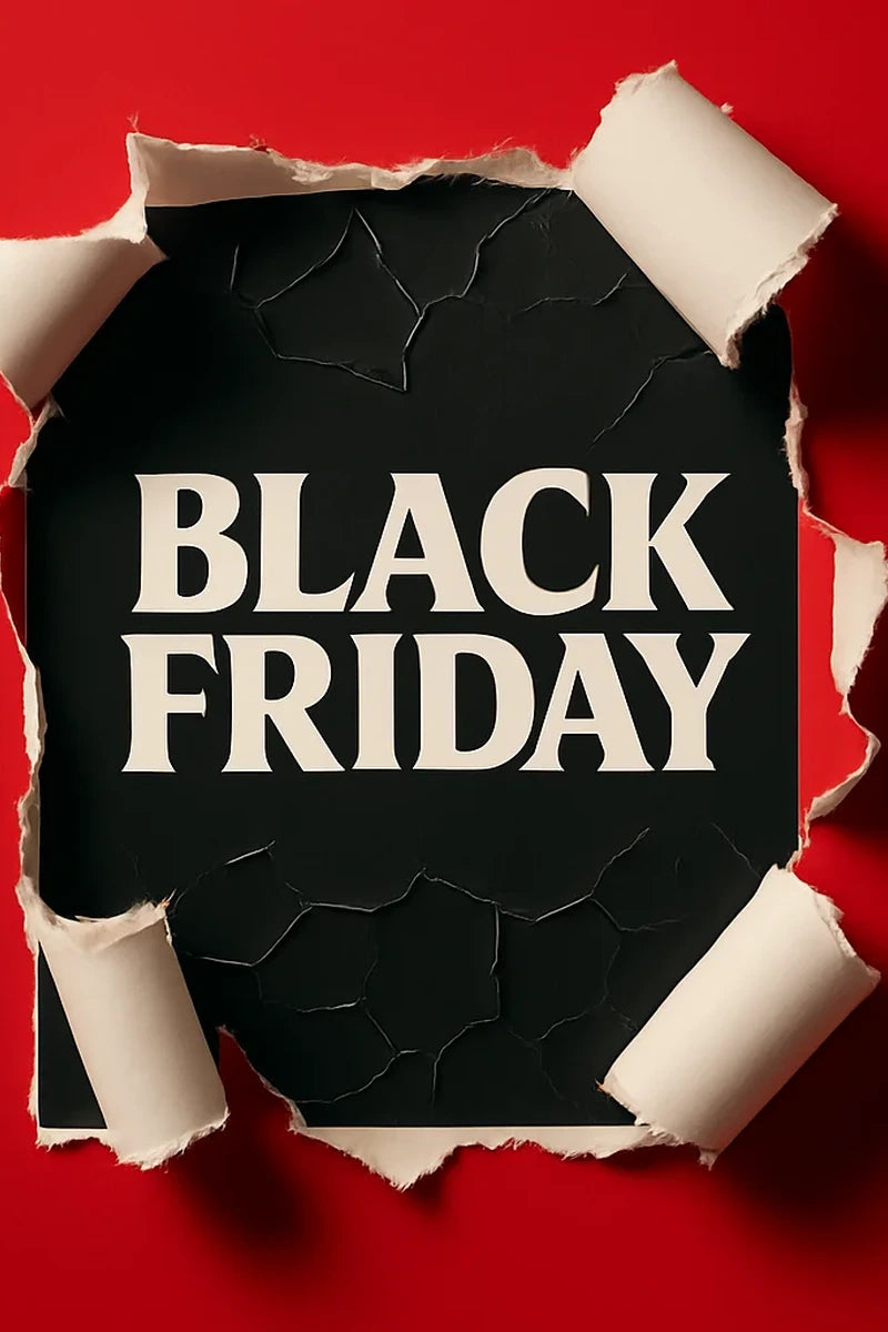 Black Friday text on a torn black paper against a red background